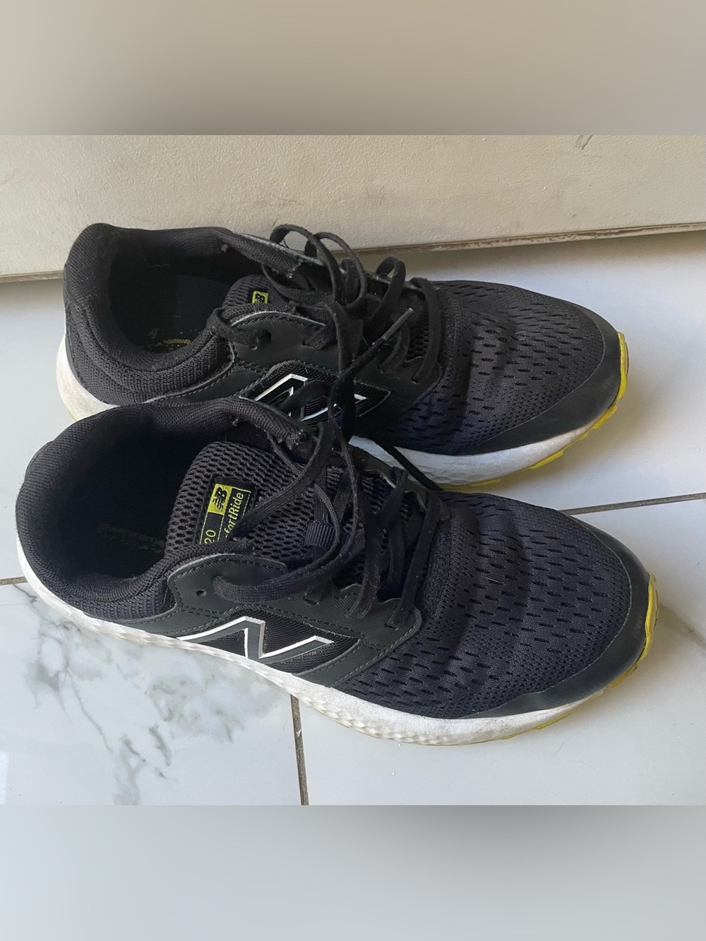 New Balance Men's Black Athletic Sneakers with White Midsole and Yellow Accents.